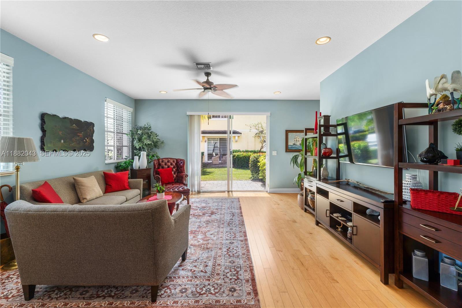 7702 Paddock Place, Unit 7702 Davie, FL 33328 - Photo 25 of 55 a living room with furniture and a flat screen tv