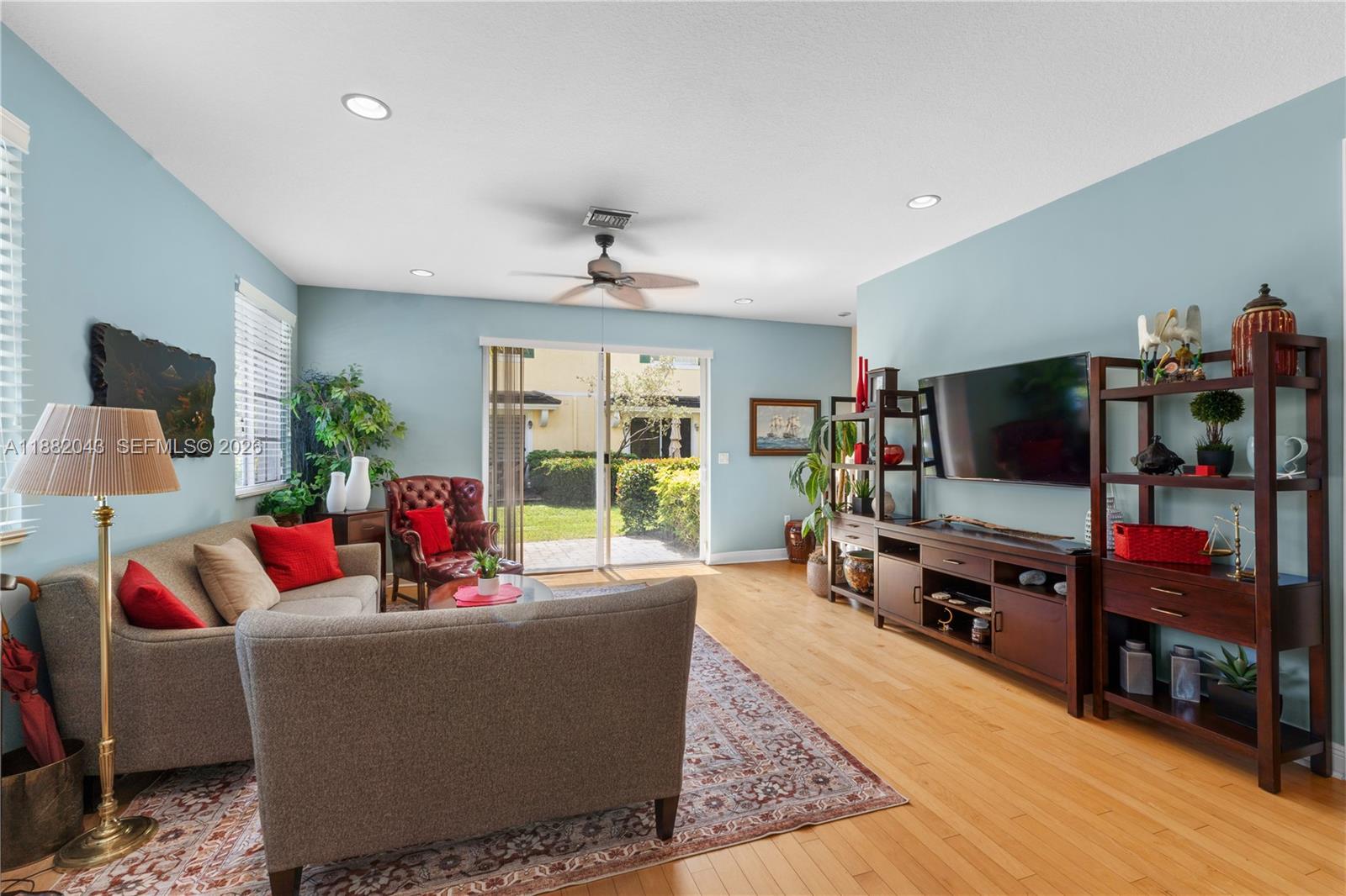 7702 Paddock Place, Unit 7702 Davie, FL 33328 - Photo 26 of 55 a living room with furniture and a flat screen tv