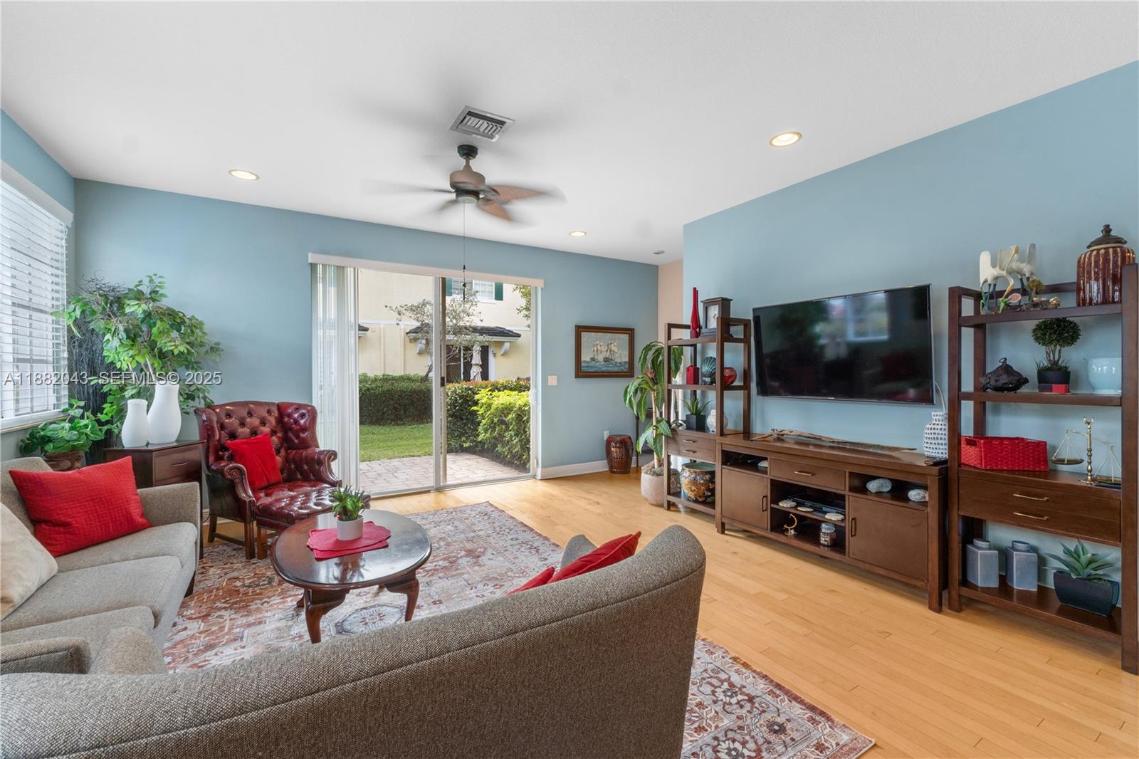 7702 Paddock Place, Unit 7702 Davie, FL 33328 - Photo 27 of 55 a living room with furniture and a flat screen tv