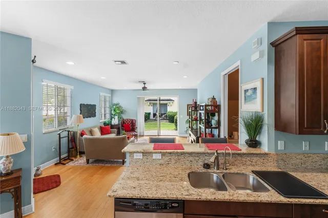 a dining room with furniture a chandelier and window