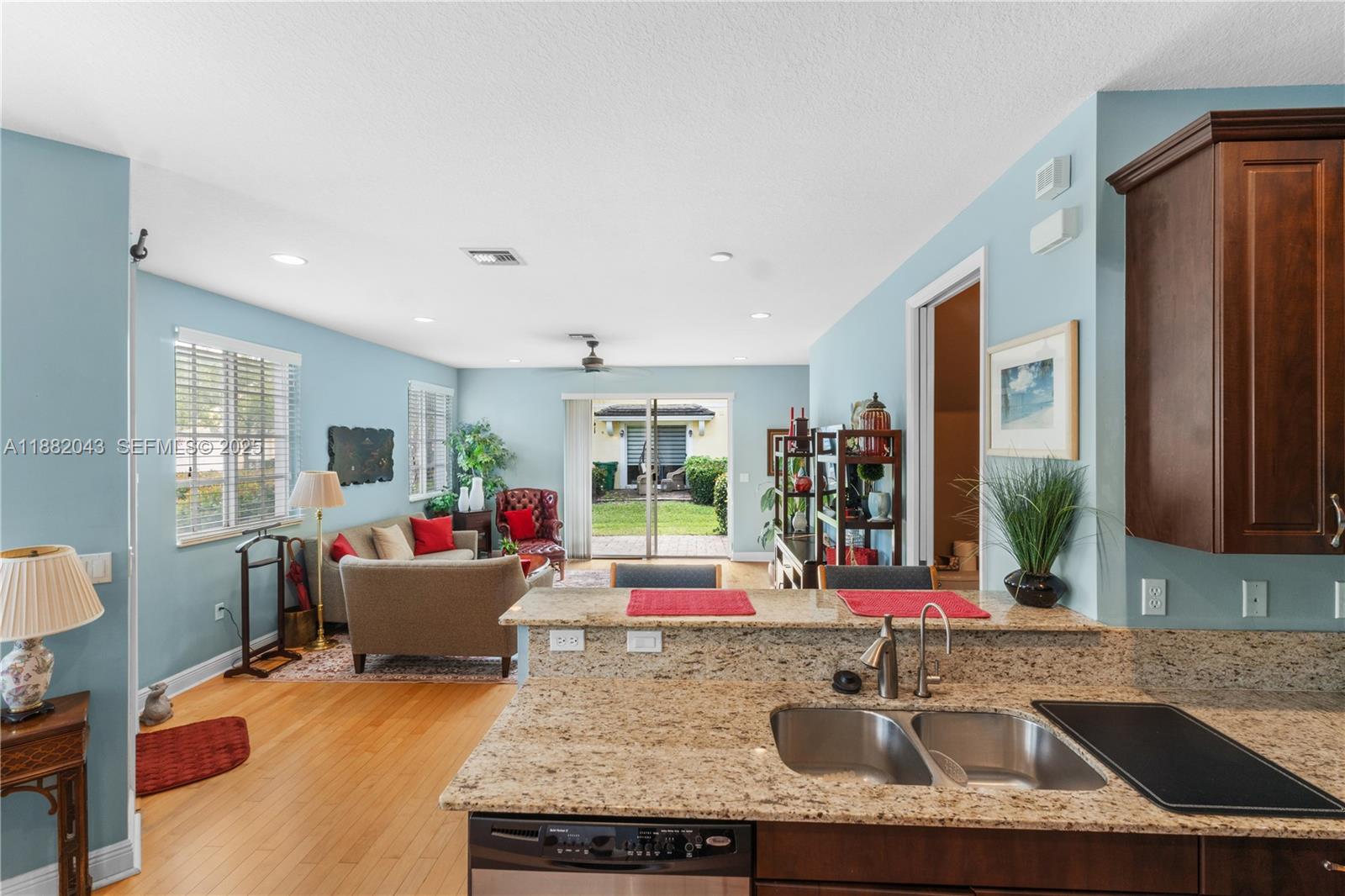 7702 Paddock Place, Unit 7702 Davie, FL 33328 - Photo 28 of 55 a living room with granite countertop kitchen island furniture and a window