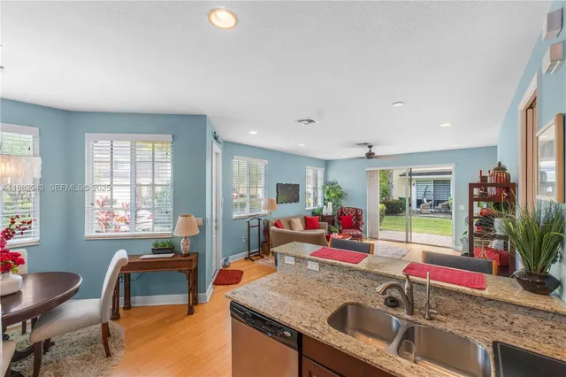 a kitchen with granite countertop stainless steel appliances and wooden cabinets