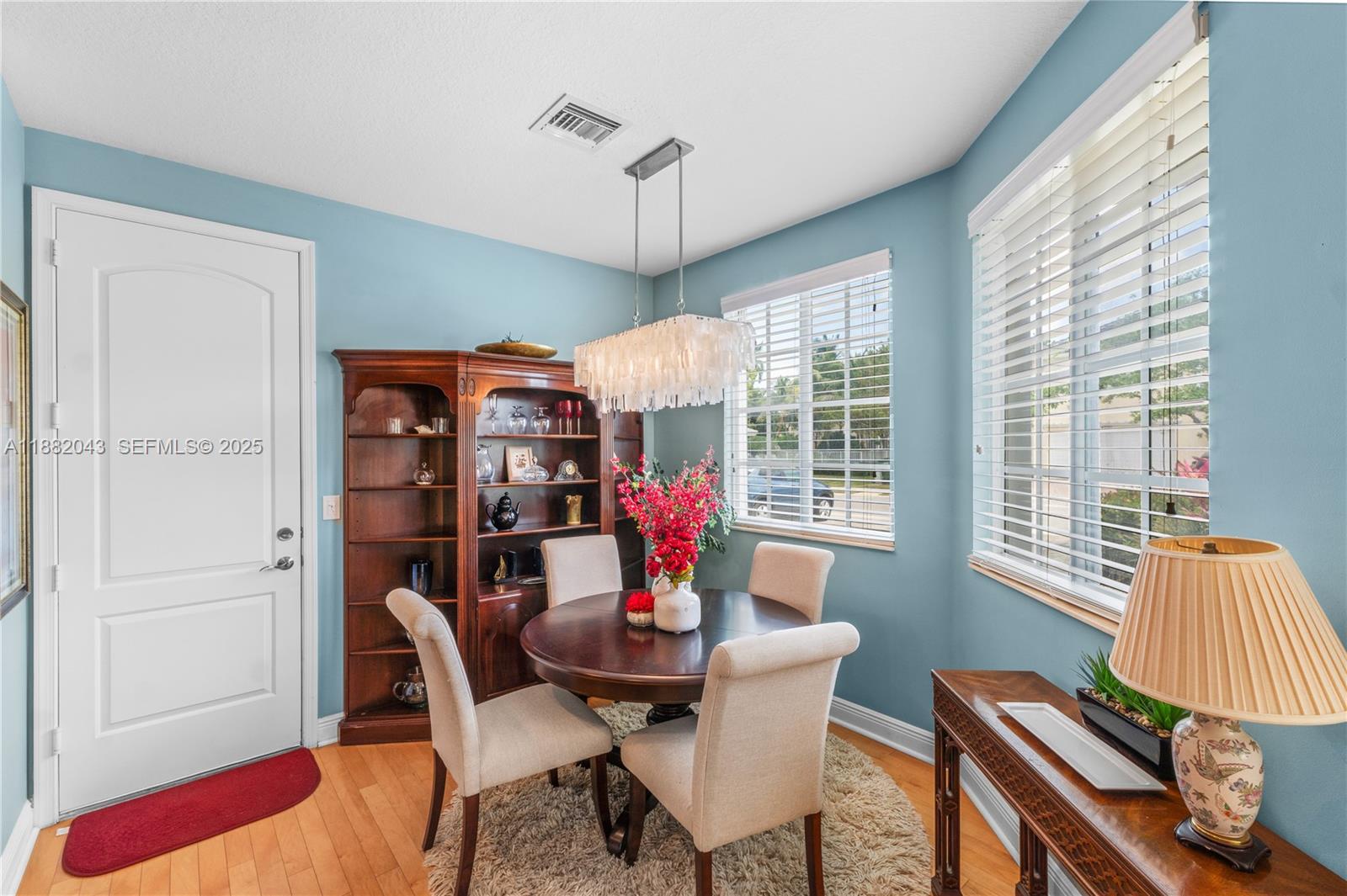 7702 Paddock Place, Unit 7702 Davie, FL 33328 - Photo 32 of 55 a dining room with furniture a chandelier and window