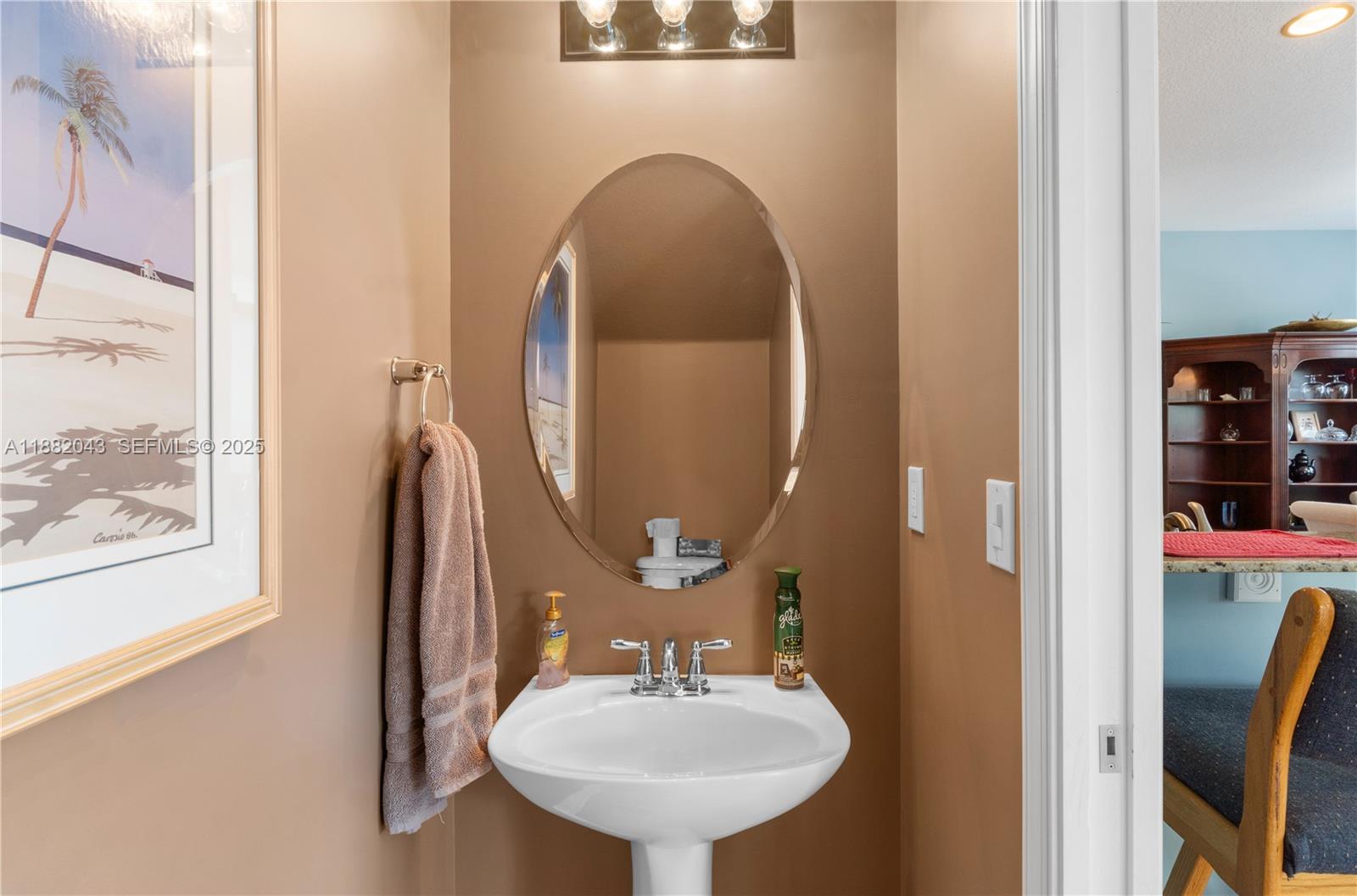 7702 Paddock Place, Unit 7702 Davie, FL 33328 - Photo 35 of 55 a bathroom with a sink and a mirror