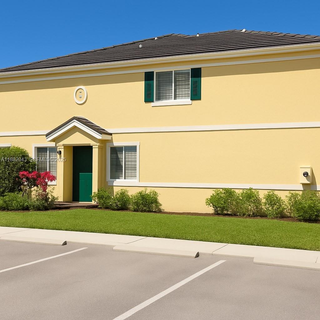 7702 Paddock Place, Unit 7702 Davie, FL 33328 - Photo 36 of 55 a front view of a house with a yard and garage