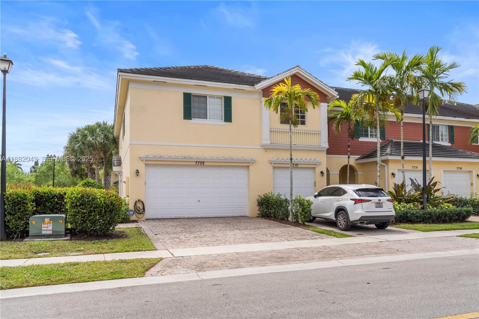 7702 Paddock Place, Unit 7702 Davie, FL 33328 - Photo 39 of 55 a car parked in front of a house with a small yard