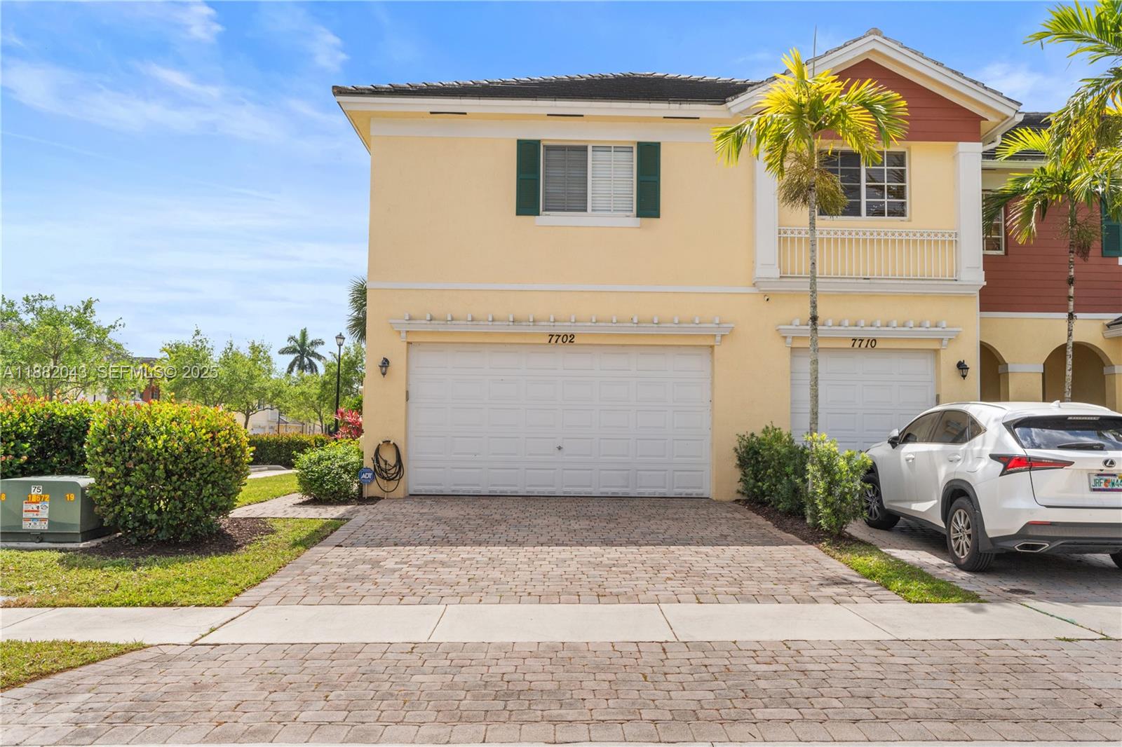 7702 Paddock Place, Unit 7702 Davie, FL 33328 - Photo 41 of 55 a front view of a house with a garden and plants