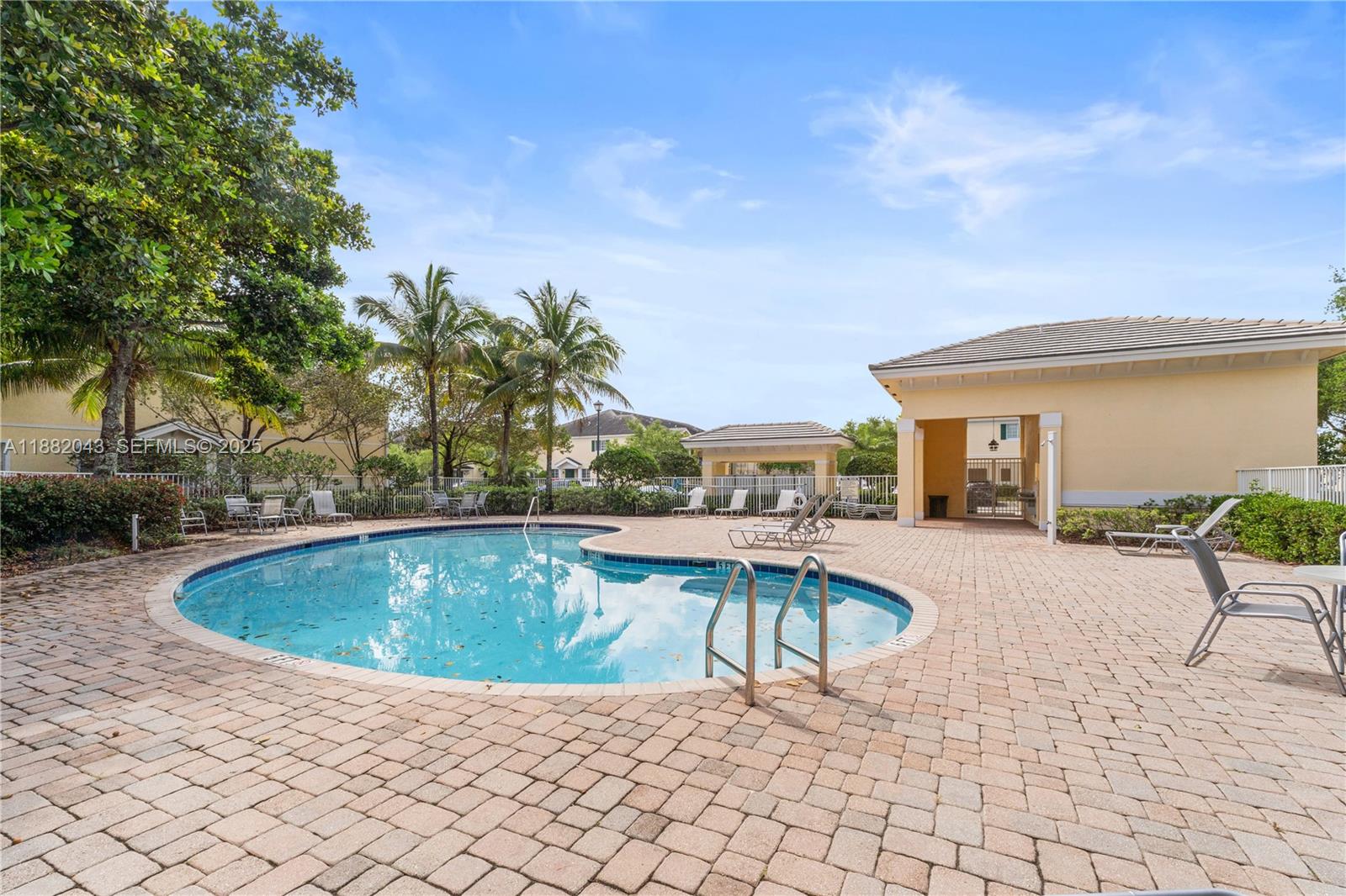 7702 Paddock Place, Unit 7702 Davie, FL 33328 - Photo 52 of 55 a view of swimming pool with outdoor seating and plants