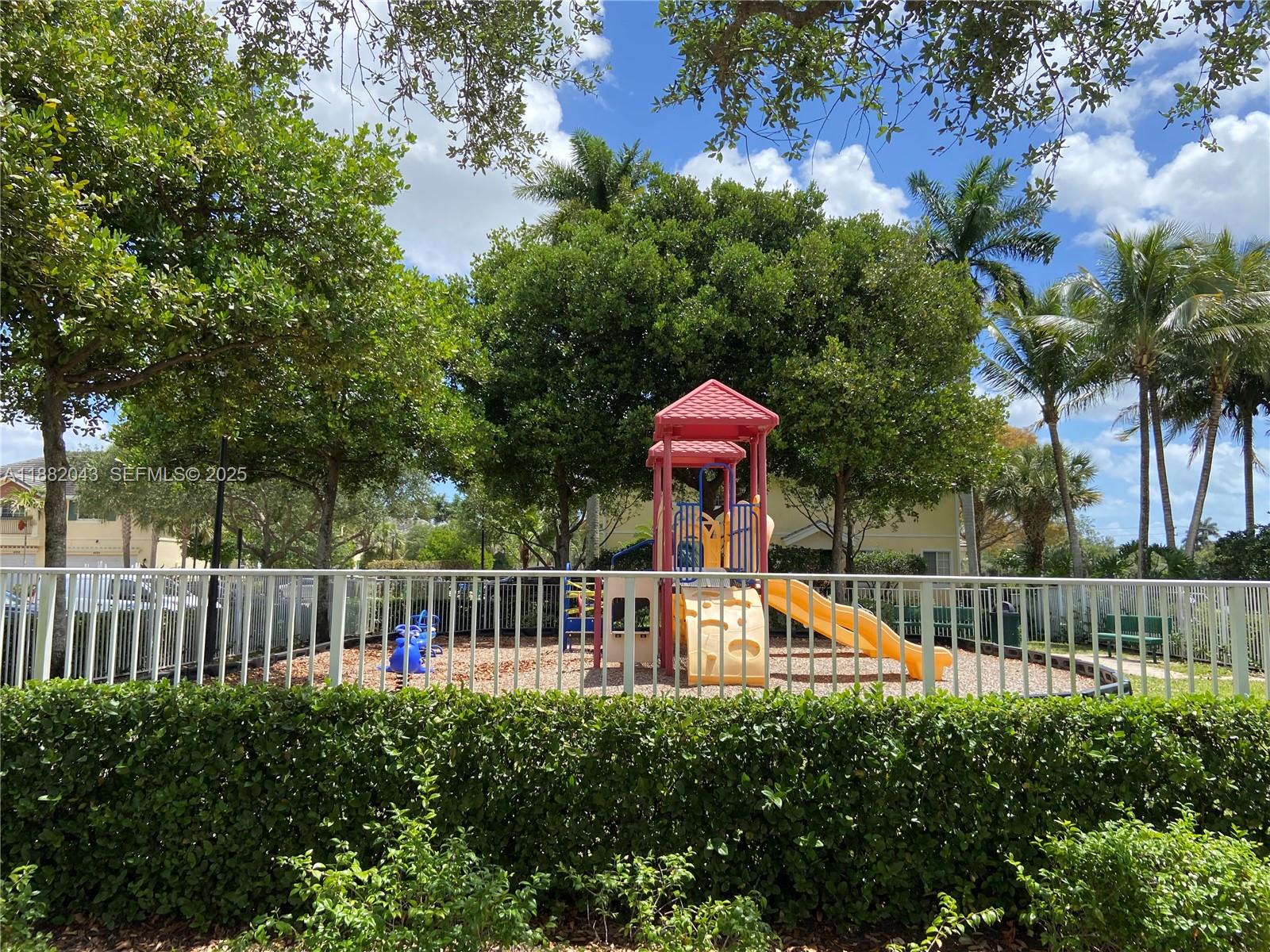 7702 Paddock Place, Unit 7702 Davie, FL 33328 - Photo 53 of 55 a view of a house with a small yard and a swimming pool