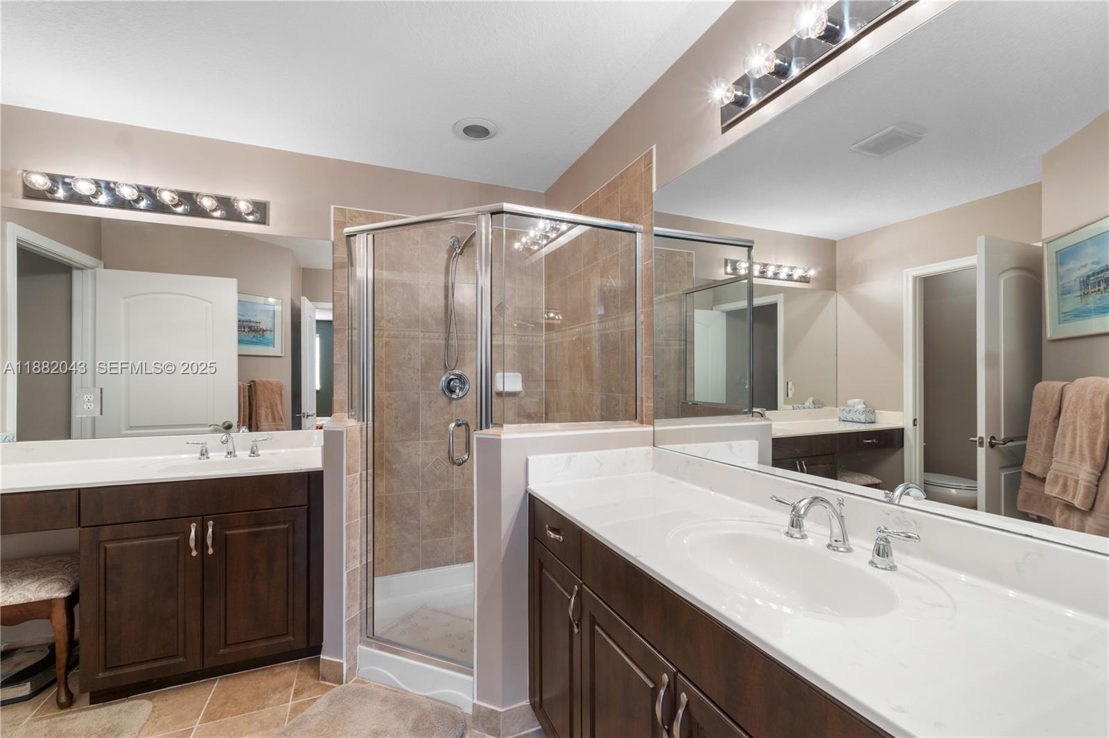 7702 Paddock Place, Unit 7702 Davie, FL 33328 - Photo 9 of 55 a bathroom with double vanity sinks and a mirror