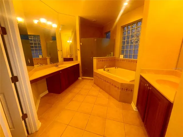 a bathroom with a tub sink and mirror