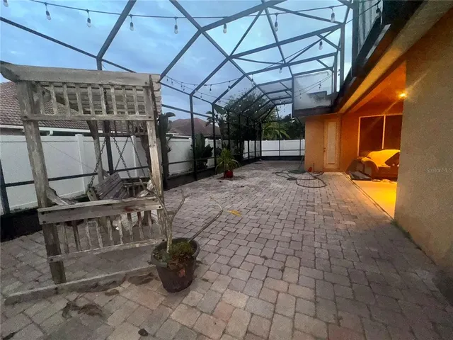 a view of a porch with a table and chairs