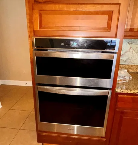 a stove top oven sitting inside of a kitchen
