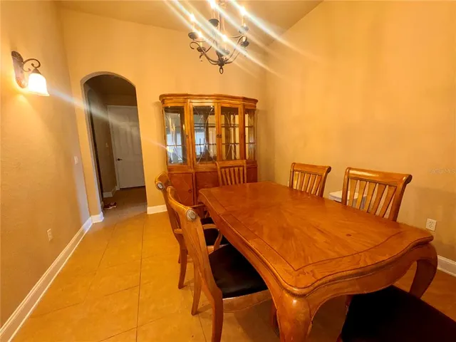 a dining room with a table and chairs