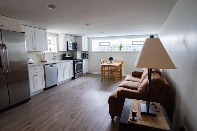 a open kitchen with stainless steel appliances granite countertop a stove and a refrigerator