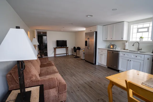 a open kitchen with cabinets a sink and a stove