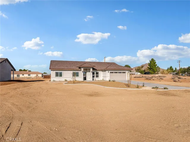 a view of a house with swimming pool and sitting area