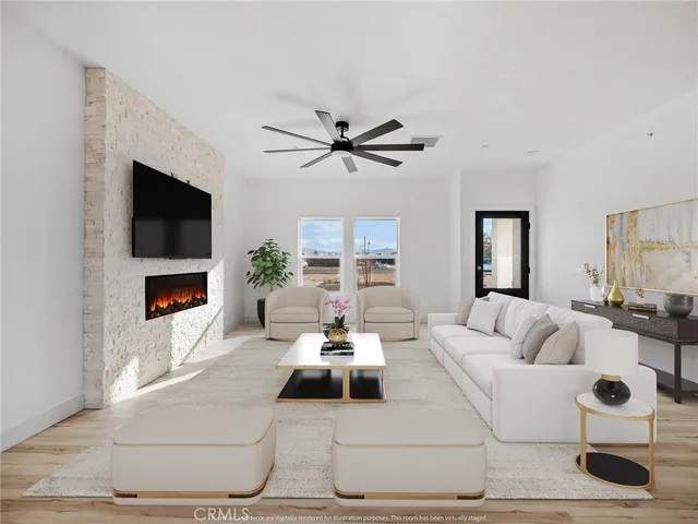 a living room with furniture chandelier and a fireplace