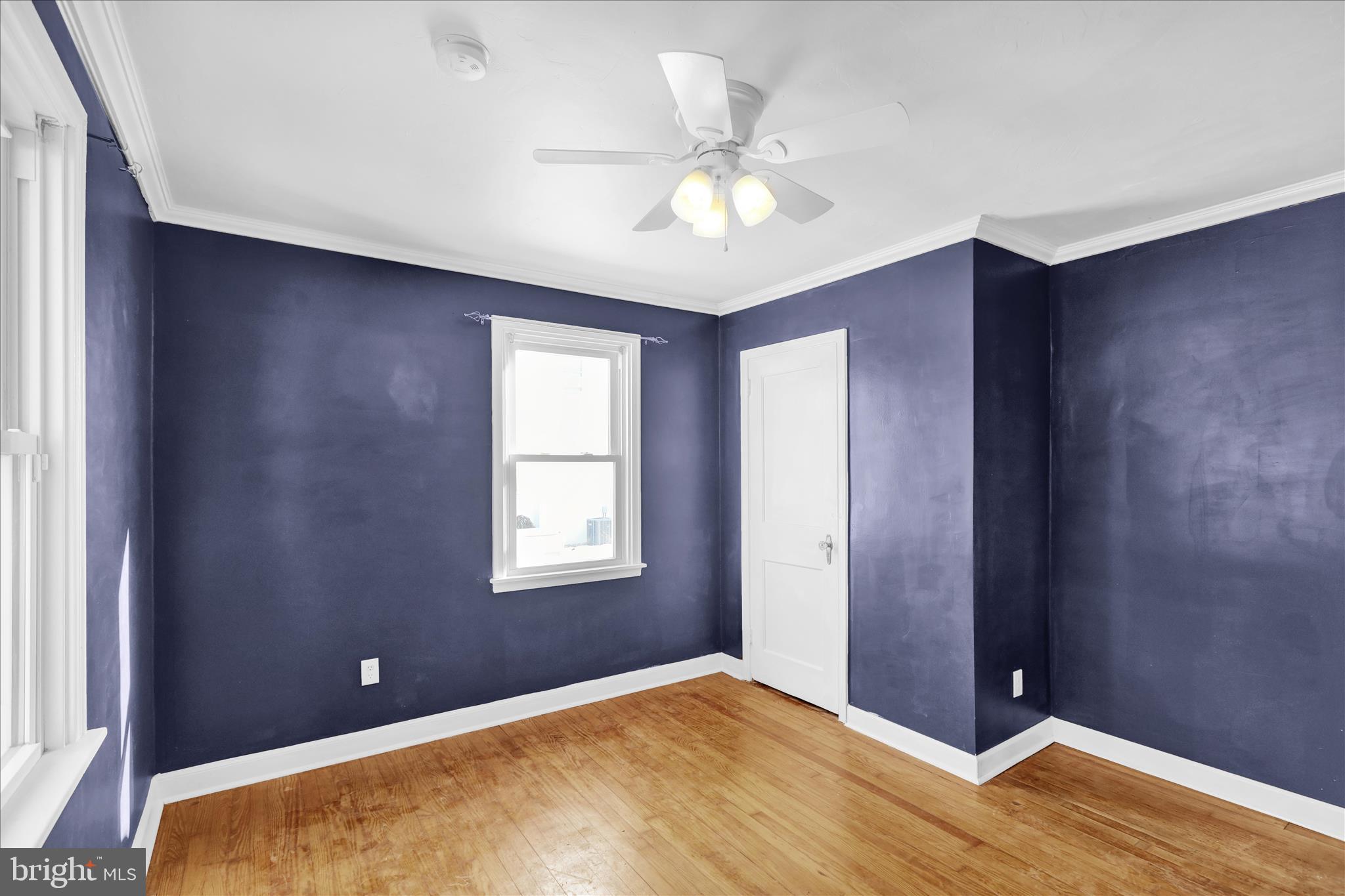 821 Bellefonte Avenue Reading, PA 19607 - Photo 16 of 37 a view of an empty room with window and wooden floor
