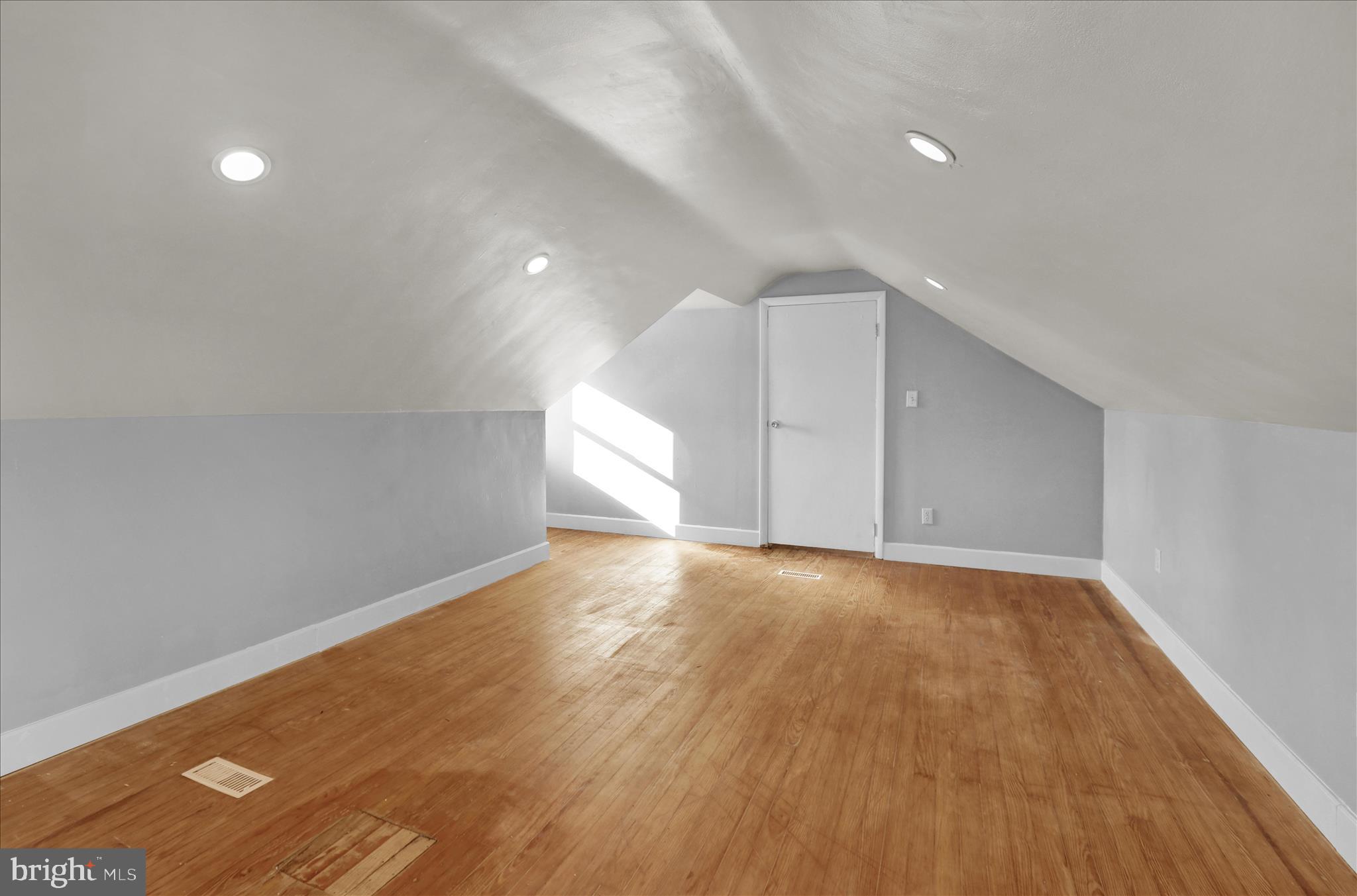 821 Bellefonte Avenue Reading, PA 19607 - Photo 18 of 37 a view of an empty room with wooden floor and a window