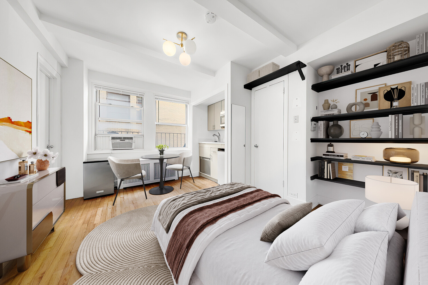 321 East 43rd Street, Unit 607 Manhattan, NY 10017 - Photo 1 of 7 a bedroom with furniture and a wooden floor