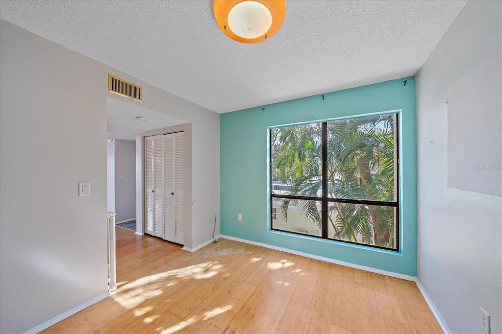 6157 Midnight Pass Road, Unit B12 Sarasota, FL 34242 - Photo 17 of 75 a view of a livingroom with wooden floor and a large window