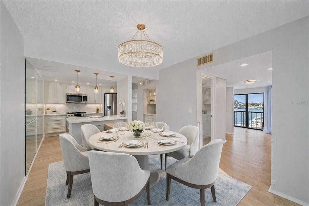6157 Midnight Pass Road, Unit B12 Sarasota, FL 34242 - Photo 18 of 75 a view of a dining room with furniture wooden floor and chandelier