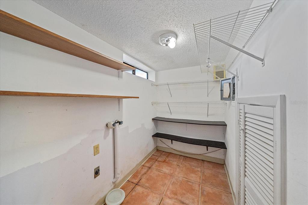 6157 Midnight Pass Road, Unit B12 Sarasota, FL 34242 - Photo 24 of 75 a view of a room with racks on the wall