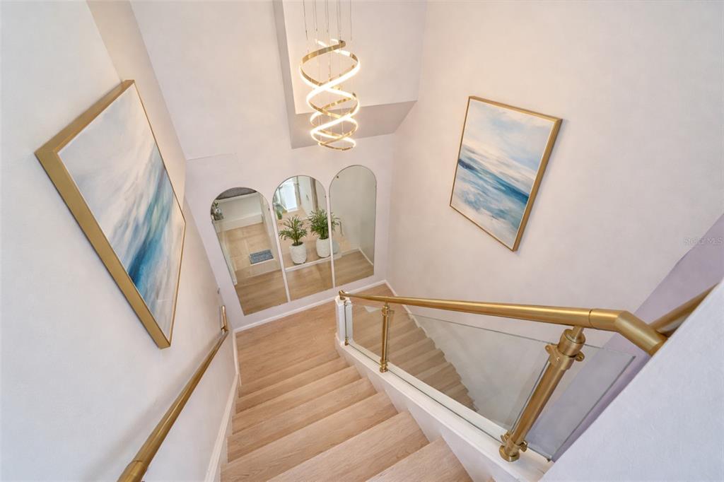 6157 Midnight Pass Road, Unit B12 Sarasota, FL 34242 - Photo 27 of 75 a view of a livingroom with wooden floor and stairs