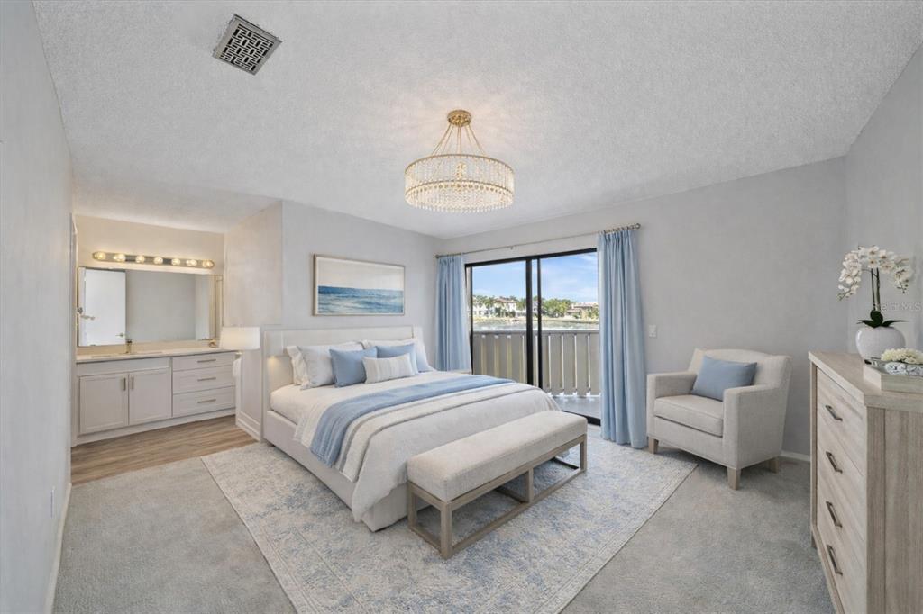 6157 Midnight Pass Road, Unit B12 Sarasota, FL 34242 - Photo 31 of 75 a spacious bedroom with a bed and a couch