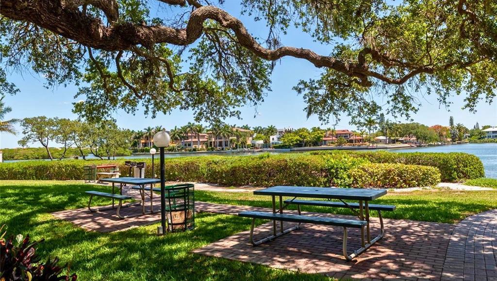 6157 Midnight Pass Road, Unit B12 Sarasota, FL 34242 - Photo 55 of 75 a view of a lake with a garden and outdoor seating