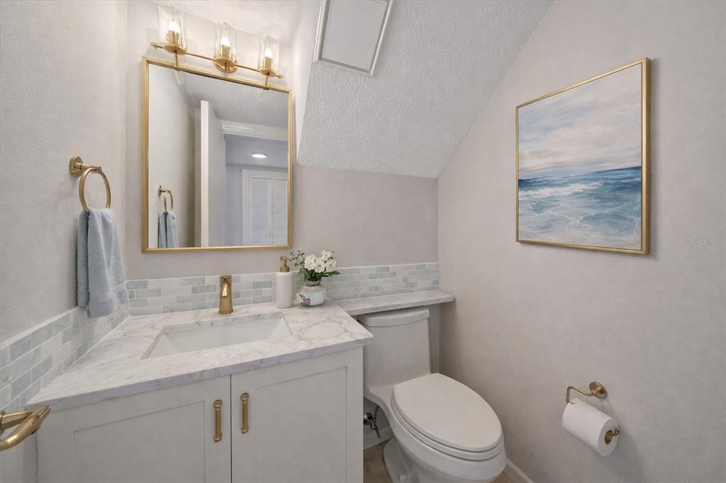 6157 Midnight Pass Road, Unit B12 Sarasota, FL 34242 - Photo 10 of 75 a bathroom with a toilet a sink and mirror
