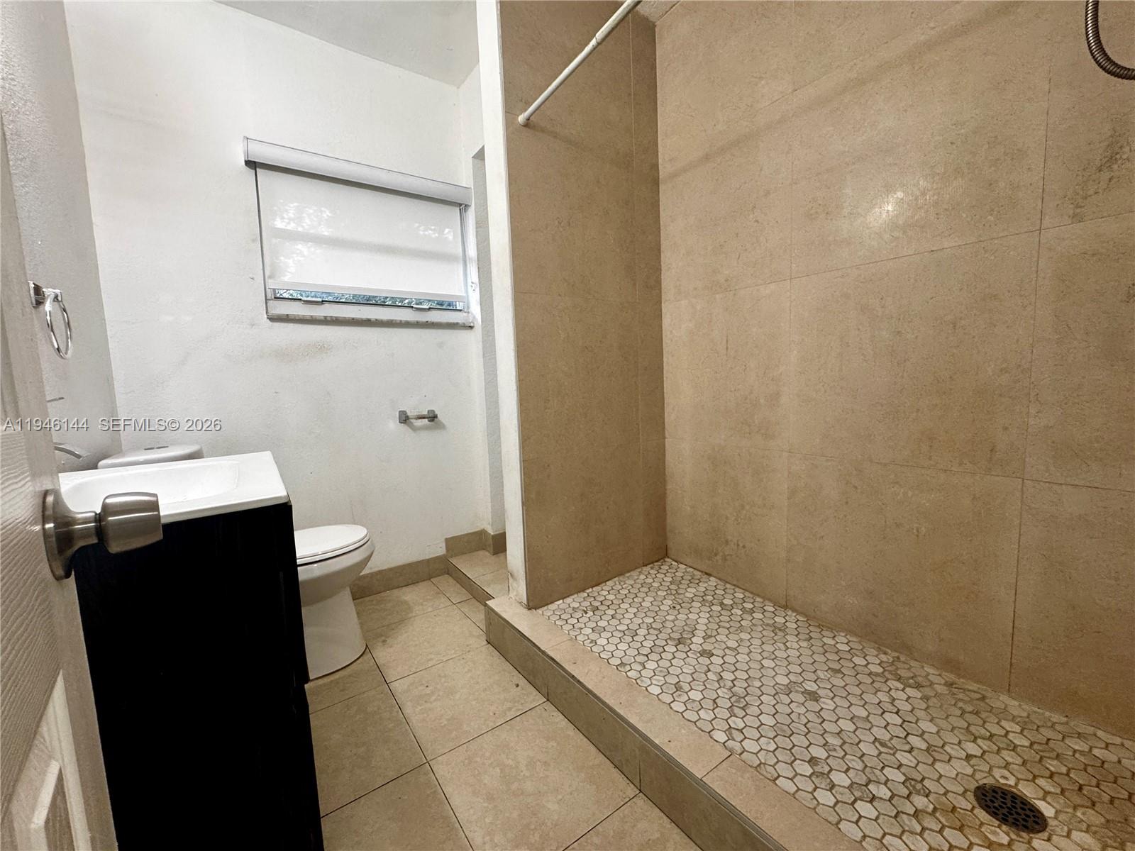 529 Southwest 3rd Street, Unit 2 Miami, FL 33130 - Photo 7 of 10 a bathroom with a sink and a toilet