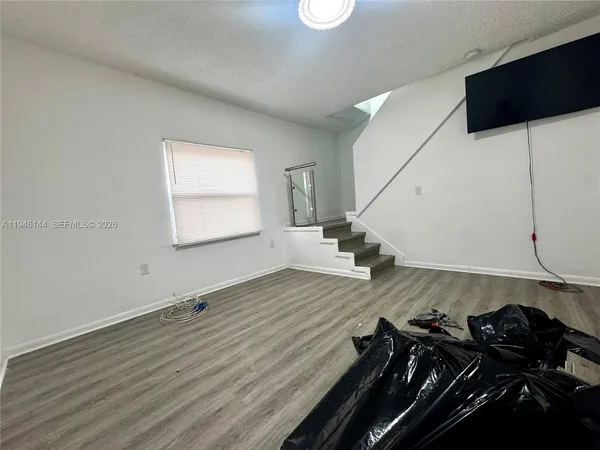 a view of a room with wooden floor and utility room