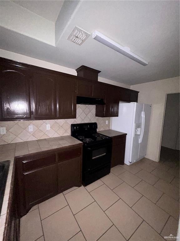 702 Jade Street, Unit B Edinburg, TX 78541 - Photo 4 of 9 a kitchen with a refrigerator and a stove top oven