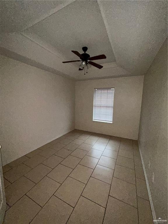 702 Jade Street, Unit B Edinburg, TX 78541 - Photo 7 of 9 a view of an empty room and window with a fan