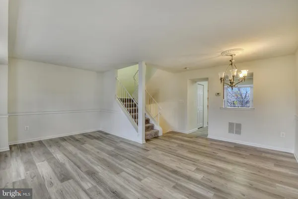 a view of a room with wooden floor and stairs