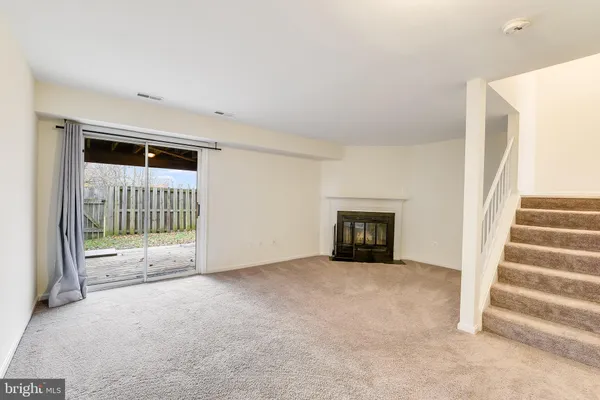 a view of an empty room and stairs
