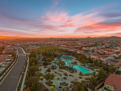 an aerial view of residential houses with outdoor space and seating
