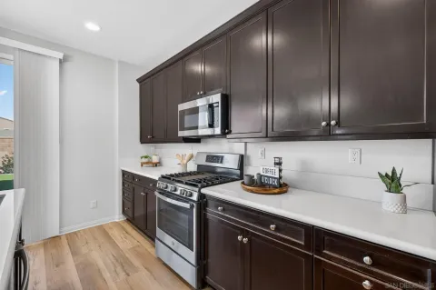 a kitchen with stainless steel appliances a sink a stove and cabinets