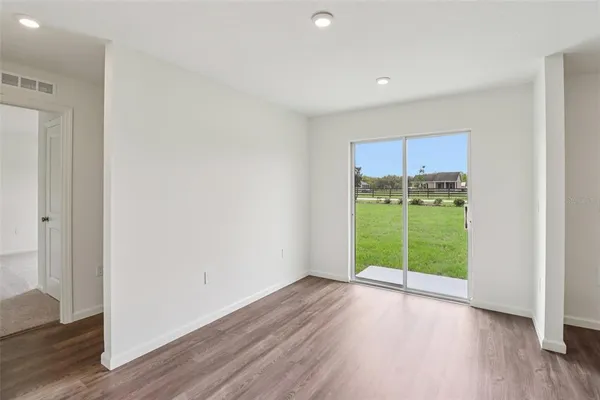 a view of kitchen with sink microwave refrigerator and outdoor view