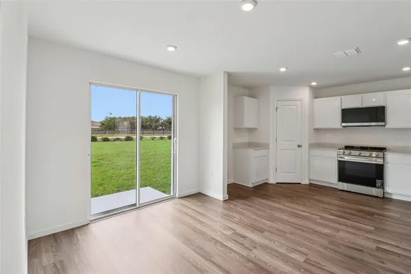 a kitchen with stainless steel appliances kitchen island granite countertop a stove and a sink