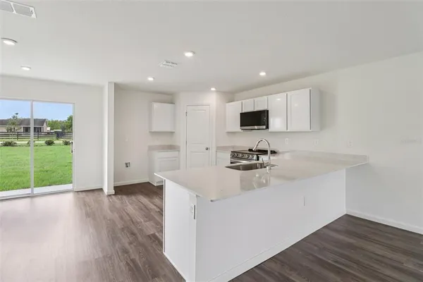 a large kitchen with a stove and a sink
