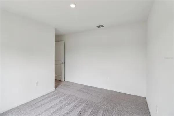 an empty room with a kitchen