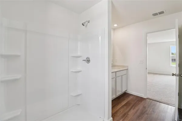 a big white house with a big yard and large trees