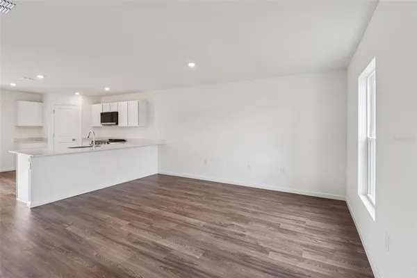 a view of a room with wooden floor