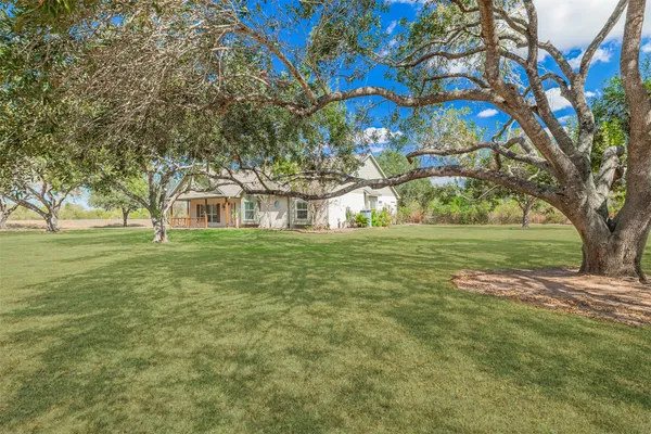 a view of white house with a yard