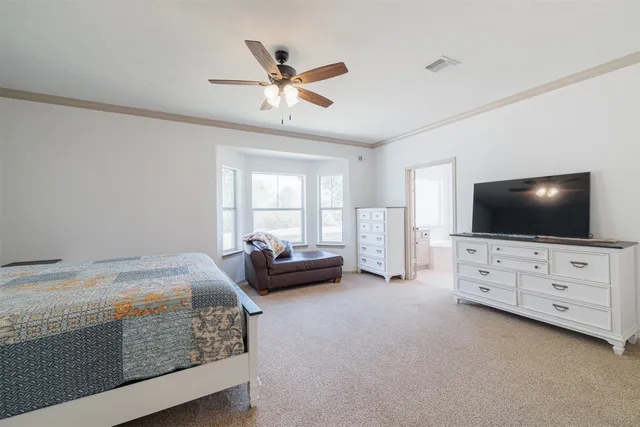 a bedroom with furniture and flat screen tv