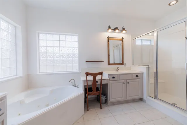 a bathroom with a tub sink and a mirror