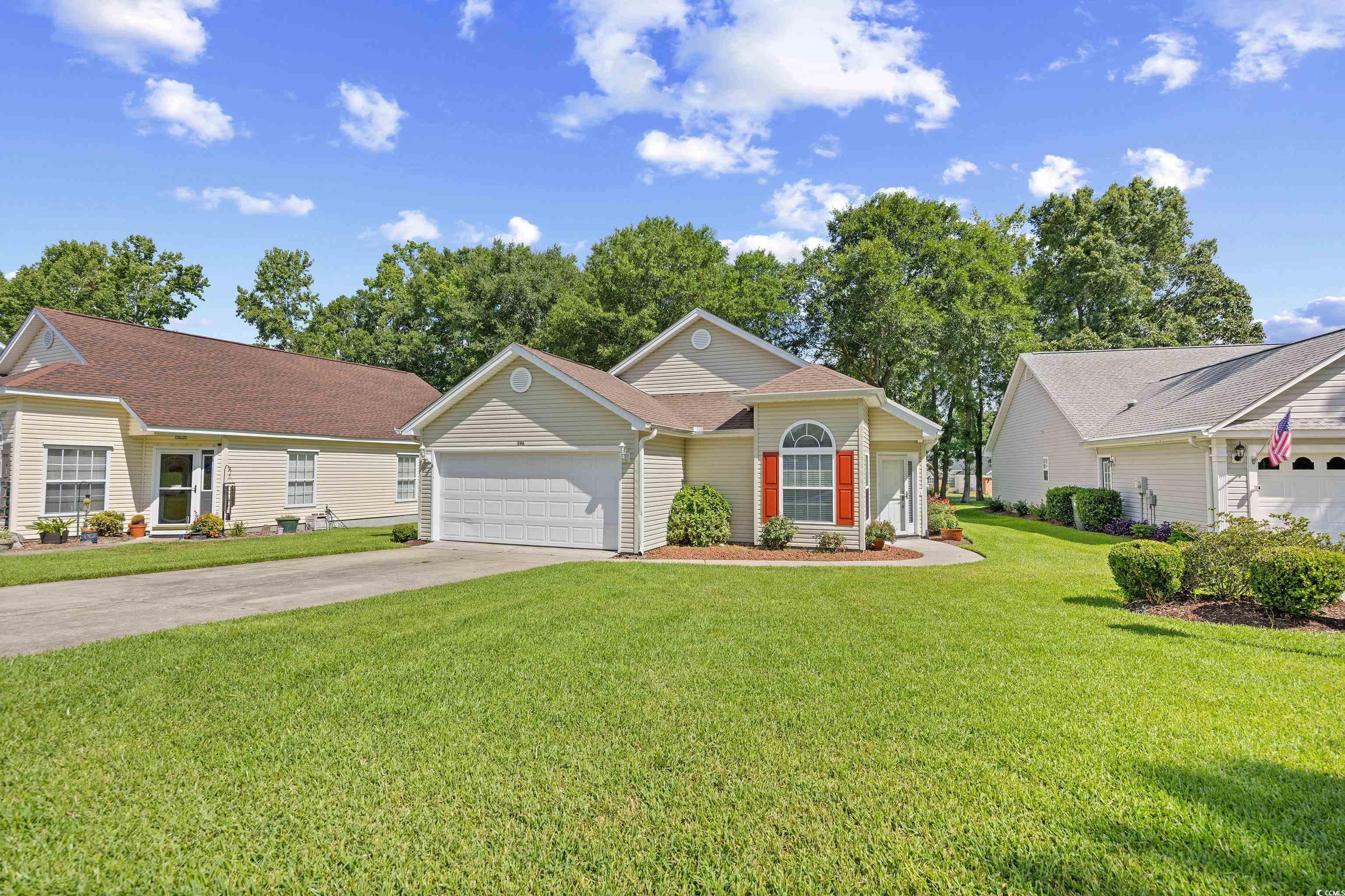 Ranch-style home with driveway, a garage, a front yard, and a shingled roof